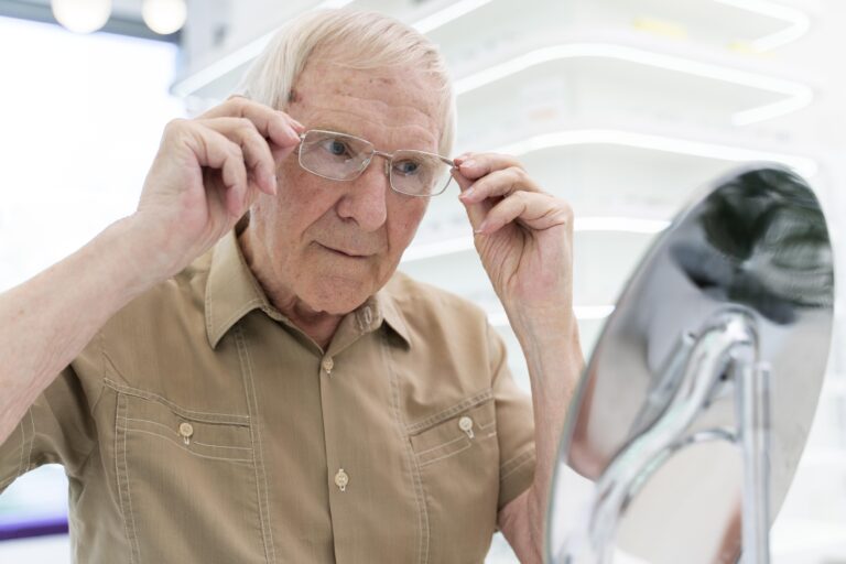 senior man trying new pair glasses