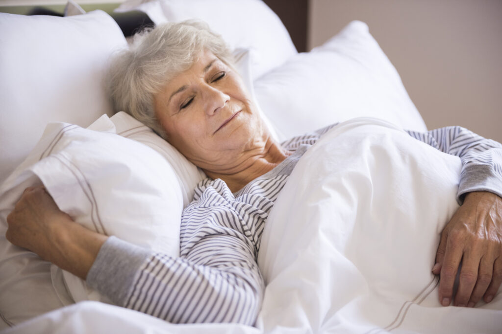 senior woman sleeping big bed